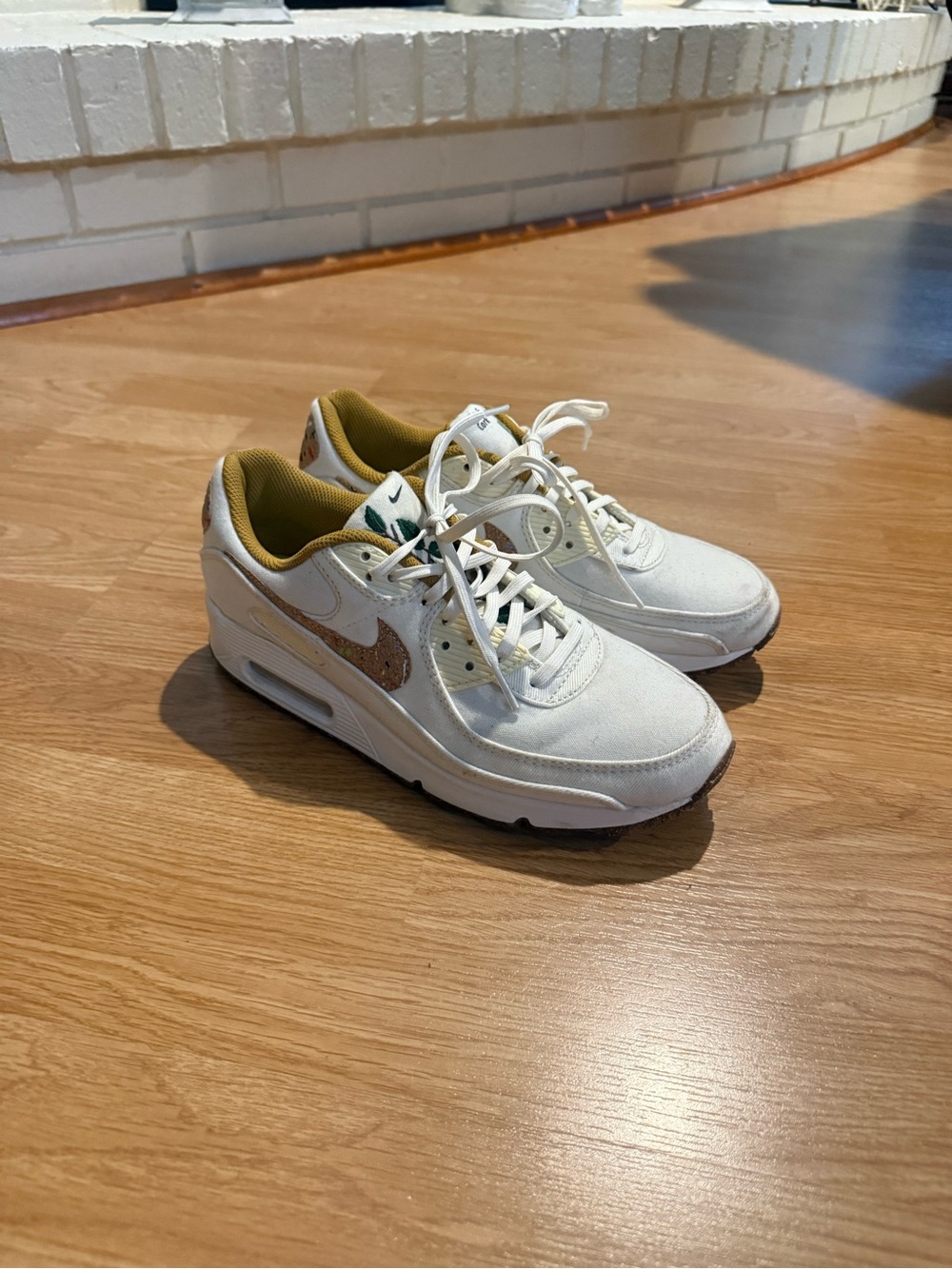 Nike Women's White Sneakers with Metallic Gold Swoosh